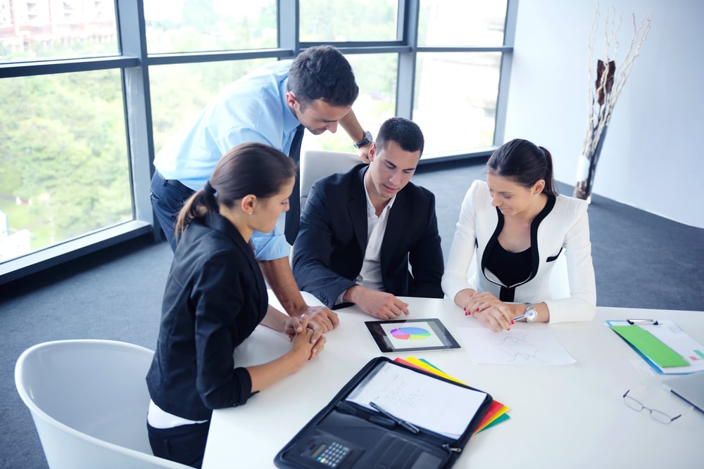 Group of happy young  business people in a meeting at office